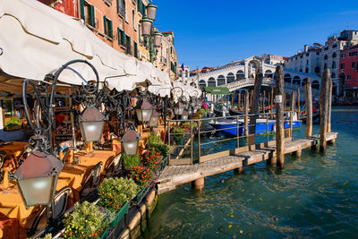 Boats in canal amidst buildings in city