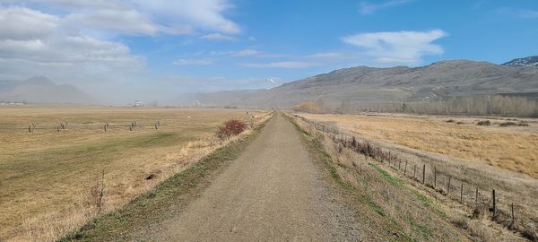 Dirt road along countryside landscape