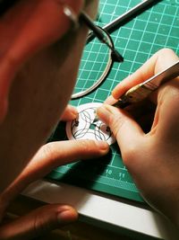Cropped hand of woman holding book