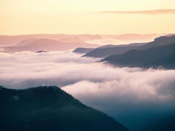 Clouds against mountain range