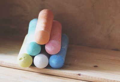 Close-up of colorful stacked chalks on table