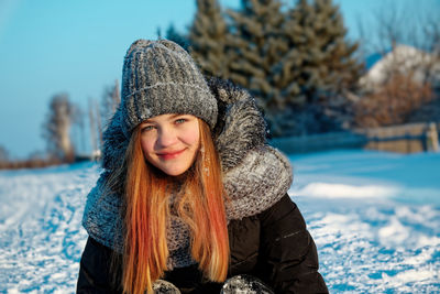 Portrait of smiling teenage girl during winter