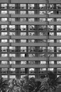 Reflection of people on building in city