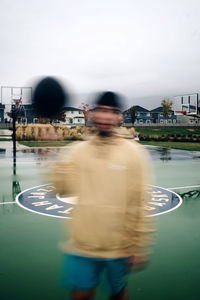 Rear view of man in water against sky