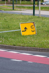 Arrow sign on road in city