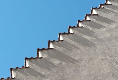 Close-up low angle view of wall against clear sky