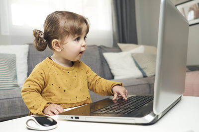 Adorable baby with a laptop