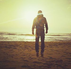 Silhouette of woman on beach at sunset