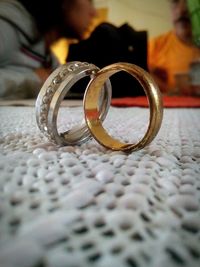 Close-up of wedding rings on table