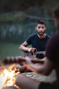 Full length of man playing guitar