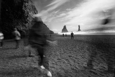 Blurred motion of people walking at beach