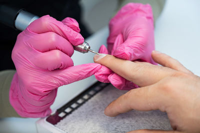 Cropped hand of person holding dental equipment