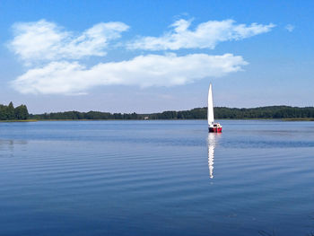 Sailboat in sea against sky