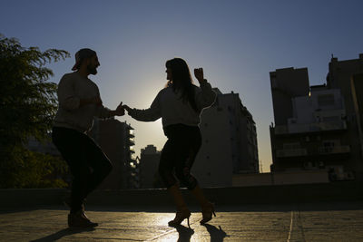 Couple dancing in a roof top in buenos aires 