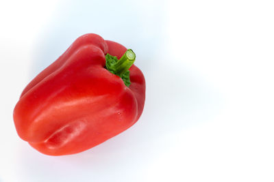 Close-up of red bell peppers against white background