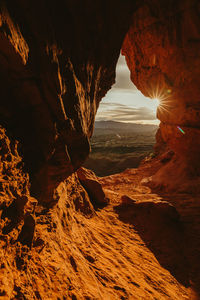 Sunset view over st. george utah from inside an orange cave
