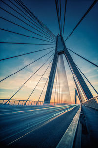 Light trails on bridge against sky