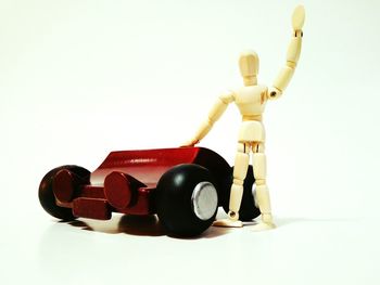 Close-up of figurine over white background