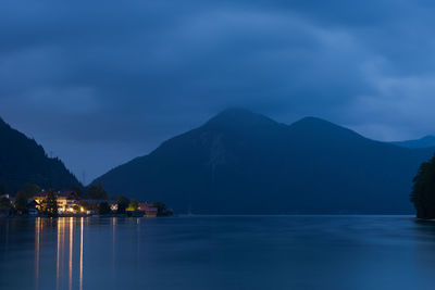 Scenic view of lake against sky at dusk