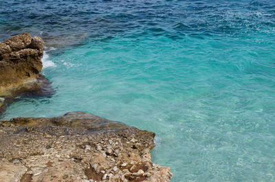 High angle view of rocks in sea