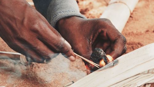 Midsection of man working on wood