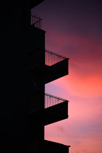 Low angle view of silhouette building against sky during sunset