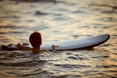 Rear view of woman in boat