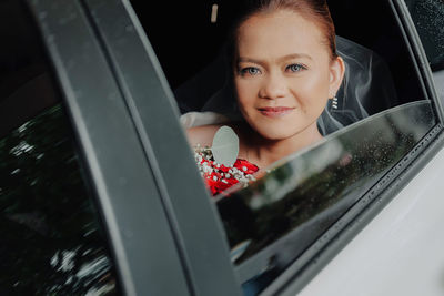 Portrait of smiling woman in car