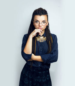 Young woman standing against white background