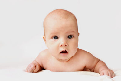 Portrait of cute baby against white background