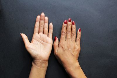 Midsection of woman against black background