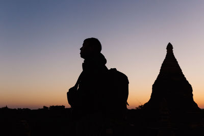 Silhouette statue against clear sky during sunset