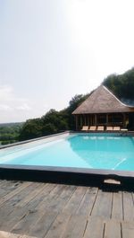 Swimming pool by building against clear sky