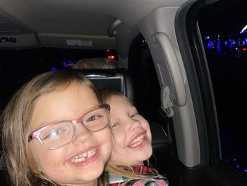 Portrait of happy girl in car