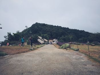 Man on mountain against clear sky