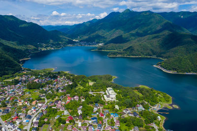 High angle view of lake and mountains against sky