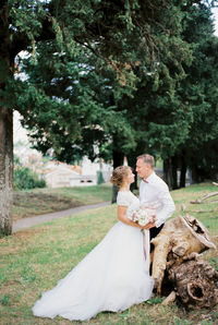 Rear view of bride and groom in park