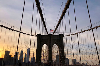 Low angle view of suspension bridge against sky