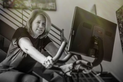 Smiling woman sitting at home