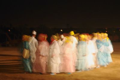 View of illuminated people at night