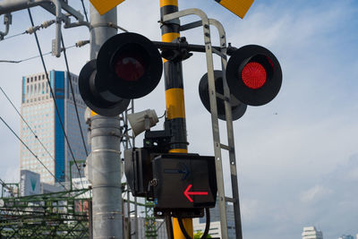 Low angle view of road signal against sky