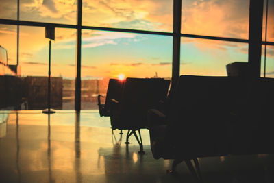 Rear view of man standing by window