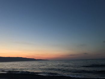 Scenic view of sea against clear sky during sunset