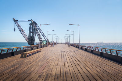 Pier over sea against clear sky