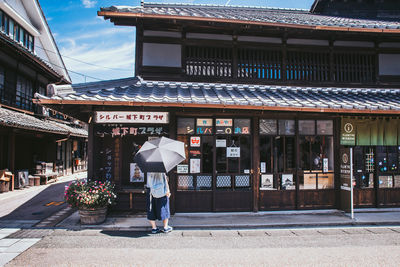 Rear view of woman walking in city