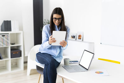 Young woman using laptop on table