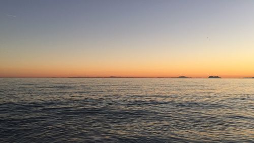 Scenic view of sea against clear sky during sunset