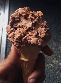 Close-up of hand holding ice cream cone