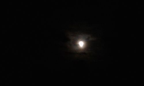 Low angle view of moon against sky at night