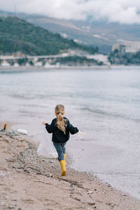 Full length of boy running on beach